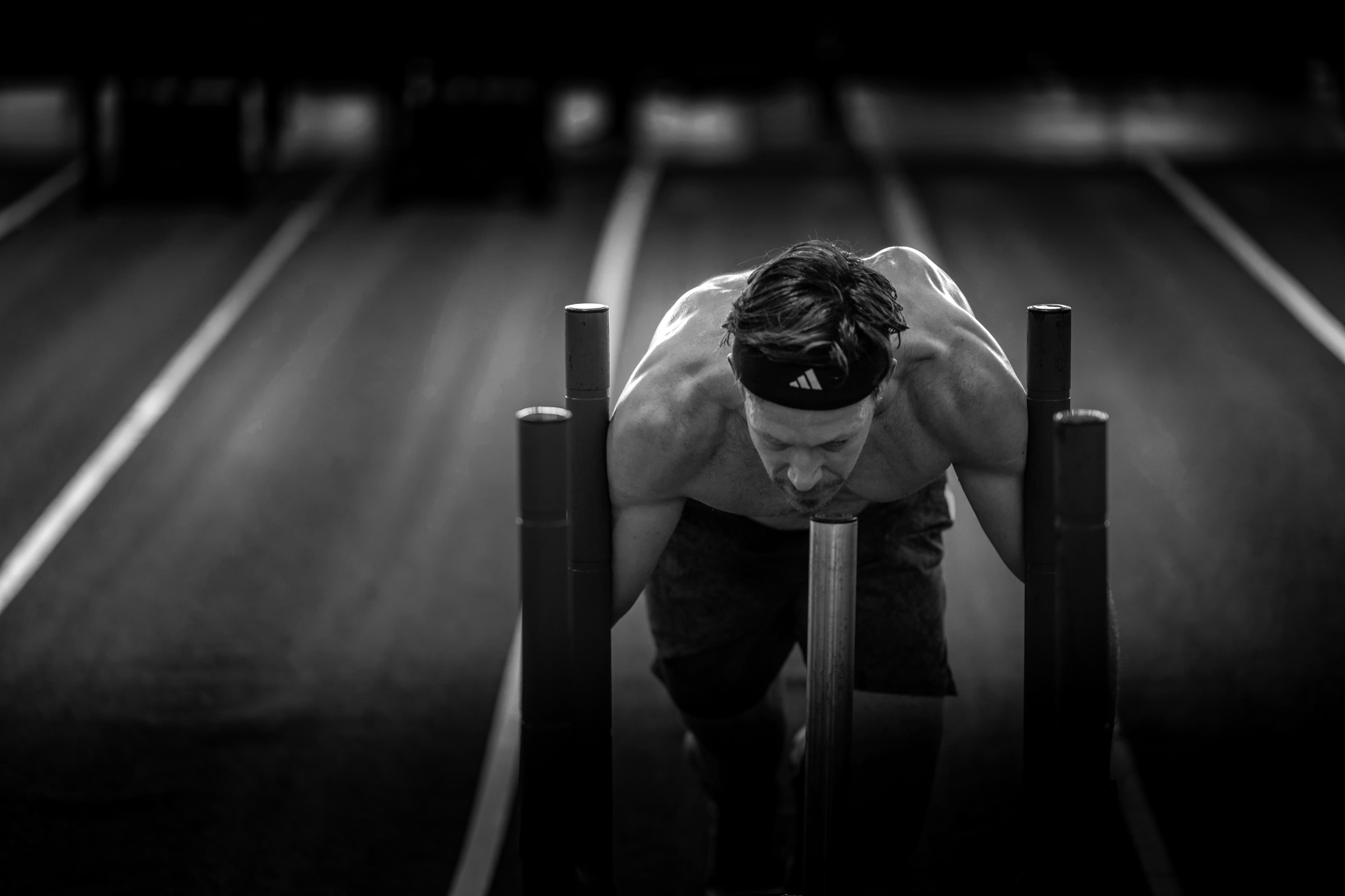 Athletes pushing a sled during HYROX training